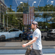 A person walks by a car dealership on June 10, 2022 in New York City. The Labor Department announced on Monday that consumer prices rose 8.6% last month from a year earlier. Inflation has risen to its highest level in four decades, raising the cost of airfare, hotels, vehicles, gas, and food.